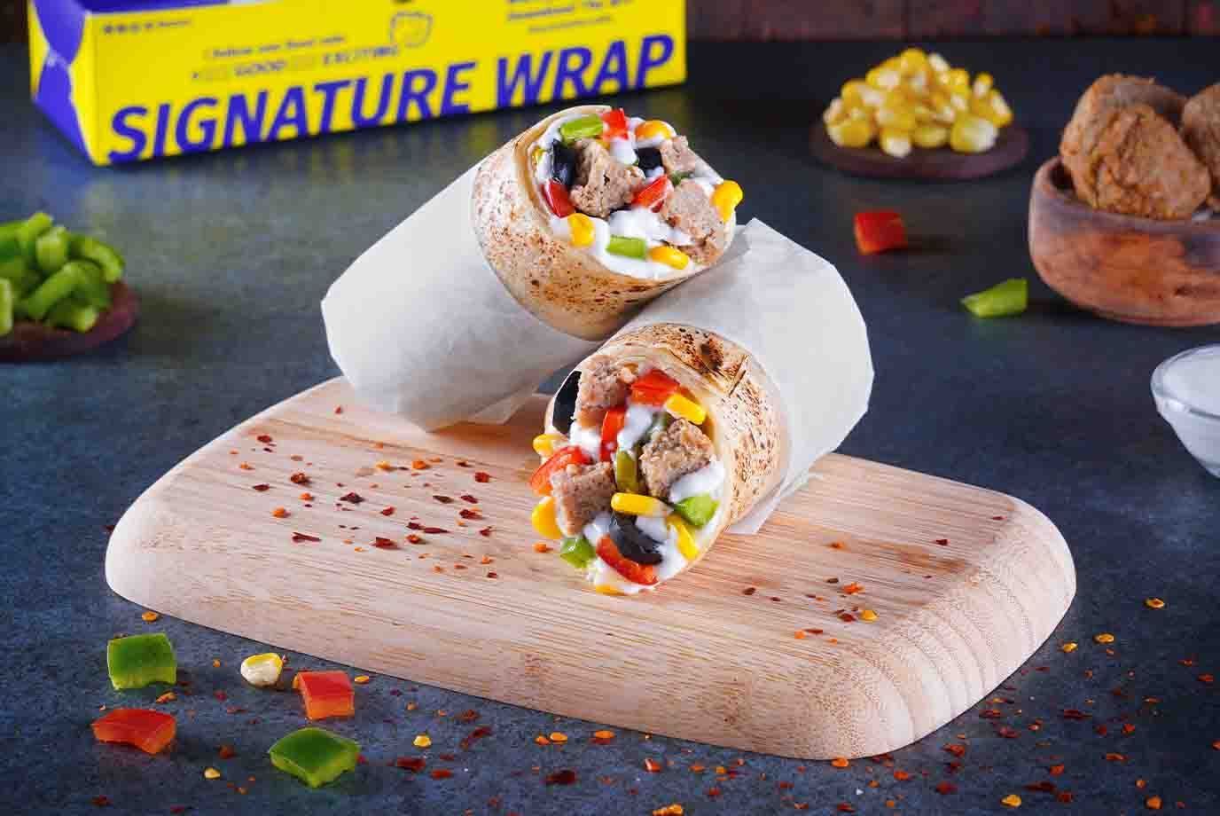 Order Baked Chicken Pizza Wrap from Signature Wraps Rolls By Faasos on